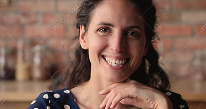 Happy beautiful young authentic hispanic woman looking at camera.