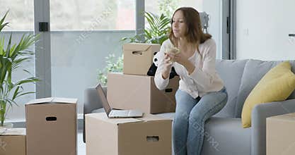 Happy woman drinking coffee in her new apartment