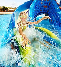 Child on water slide at aquapark.