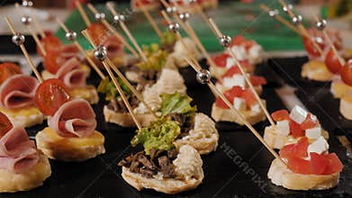 Close-up view of chef serving delicious canapes