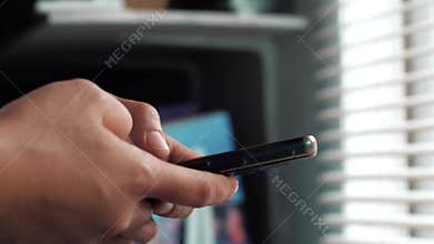 Close up of woman holding and using smart mobile phone, scrolling browsing internet on gadget