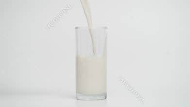 Slow Motion of Pouring Milk in Glass at 1000fps, Blue Background