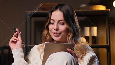 Portrait Of A Woman Writing In Notepad, Creating Agenda Or Schedule At Home