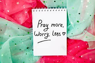 Pray more worry less - christian lettering on pink and green textile background, card with text
