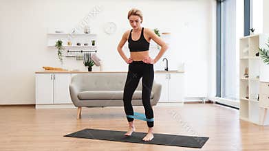 Woman doing home workout with resistance band exercise