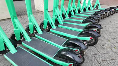 Row of electric scooters for public share. Electric urban transportation