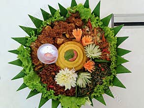 Tumpengan served with a variety of side dishes that are usually served for certain events is typical of Infonesia