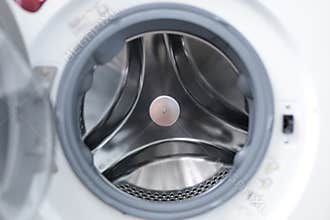 Stainless steel materials used in washing machines. Front-loading washing machine, interior material made of stainless steel.