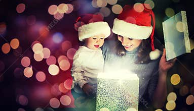 Christmas magic gift box and a happy family mother and baby