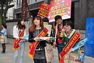 Pengzhou, China: Teens Handing Out Advertising Brochures