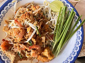 Fried noodle Thai style with prawns , street Thai food.