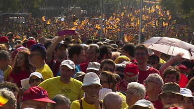Crowd of People with Catalan Flags on the Street