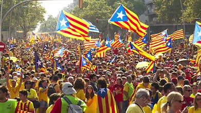 Crowd of People with Catalan Flags on the Street