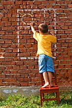 Boy drawing sun and window