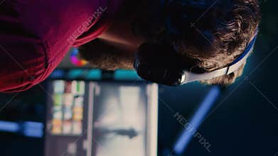 Vertical video Videographer adjusting clips while listening music in headphones