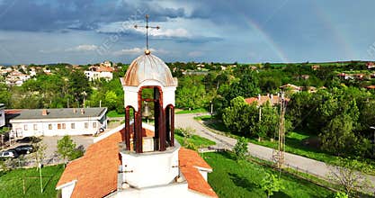 Bulgarian christian church in the countryside and beautiful bulgarian nature with rainbow in sky
