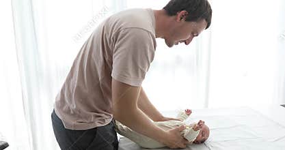 Sweet tender moment of smiling young dad lying play with cute baby daughter