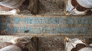 Ancient Egyptian hieroglyphs and bas-reliefs close-up in Dendera temple or Temple of Hathor. Egypt. Dendera Temple