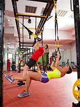 Fitness TRX training exercises at gym woman and man