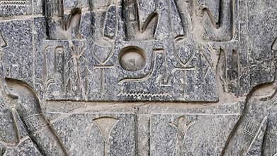 Ancient Egyptian hieroglyphs and bas-reliefs close-up in Luxor Temple, ancient Thebes, Egypt. Luxor Temple is a large