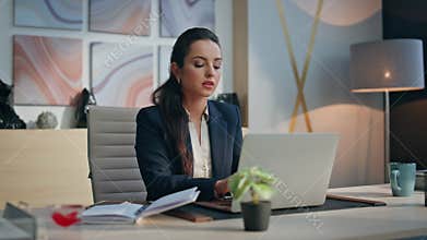 Serious author writing notebook working with inspiration at cabinet closeup
