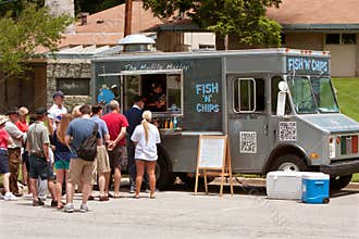 People Wait In Line At Fish and Chips Food Truck