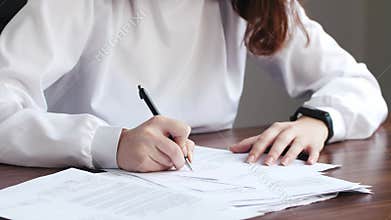 Young caucasian woman doing contract signature, employee documents and writing on agreement paper in work office