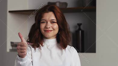Portrait of young adult brunette woman beautiful positive cute model girl posing indoor, looking at camera, showing hand