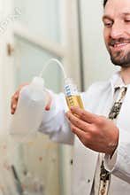 Beer Brewer in food laboratory examining
