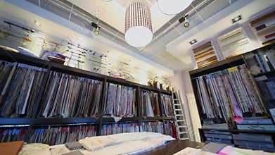 Panorama of shop interior with many fabrics on
