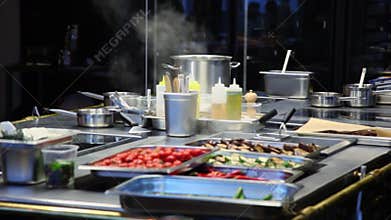 Steam fumes above meals and kitchen utensils near