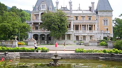 Beautiful Massandra Palace with pond and violets.