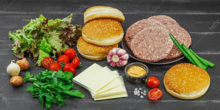 Burger patties. Beef cutlets, buns, vegetables and sauce. Homemade American classic