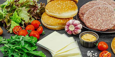 Burger patties. Beef cutlets, buns, vegetables and sauce. Homemade American classic