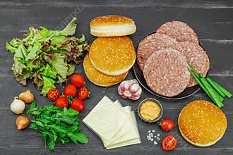Burger patties. Beef cutlets, buns, vegetables and sauce. Homemade American classic