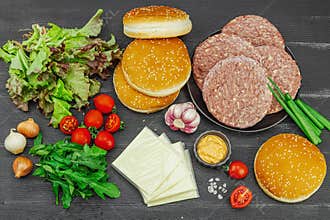Burger patties. Beef cutlets, buns, vegetables and sauce. Homemade American classic