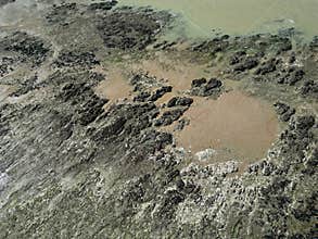 Bomb craters marks visible along the rocky shoreline, Normandy, France