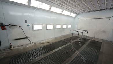 Small empty paint-spraying booth with grey metal