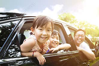 little girls with family sitting in the car