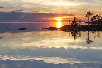 Sunset over Lake Ladoga with almost perfect reflection