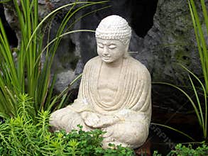 Serene little Buddha in garden