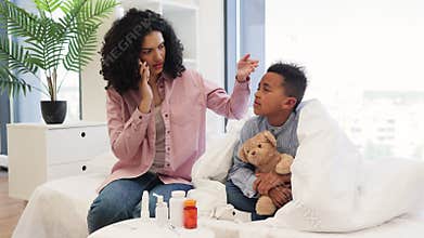 Mother cares for sick son while talking to doctor on phone