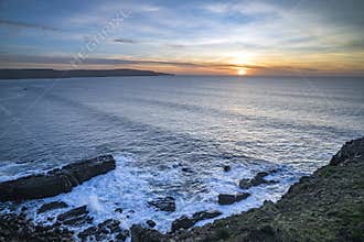 Sun setting over Widemouth Bay Cornwall