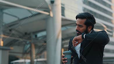 Man in suit communicating with colleague through smartwatch
