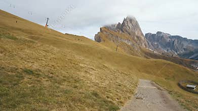 famous Mount Seceda in the Dolomites. Mountain trail in Alps mountains in autumn or winter. Beautiful alpine mountains