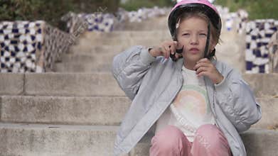 Beautiful blonde girl putting a cycling pink helmet on her head