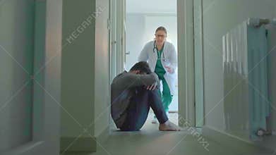 Female doctor trying to help male patient with mental disorder