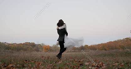 bride in white wedding dress and groom circling