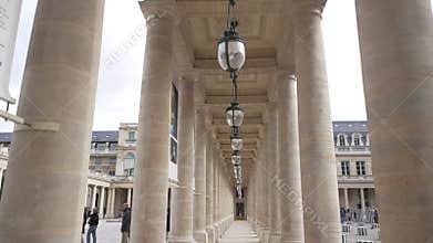 Paris, France: October 25, 2023: Le Palais Royal, lamps row hanging as vintage exterior decoration. Columns and lighters