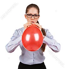 Stylish girl inflates a big red ball